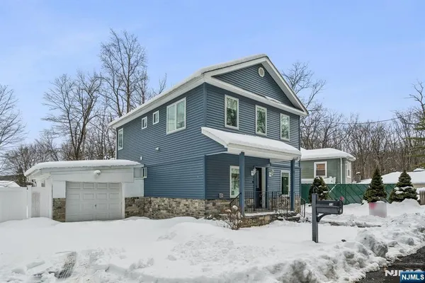a view of a house with a yard covered in snow