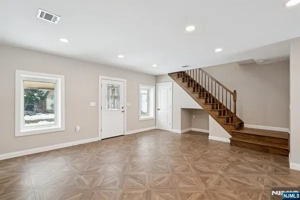 a kitchen with stainless steel appliances granite countertop a sink a stove and a refrigerator