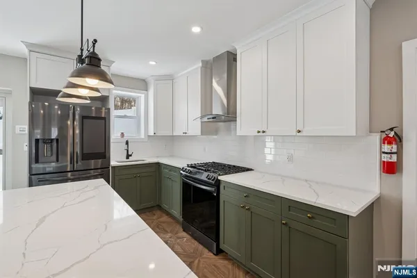 a kitchen with kitchen island a stove a table and chairs in it