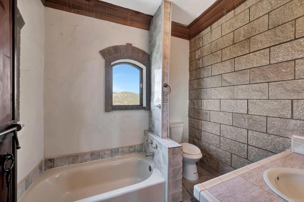 19105 Laminack Lane Jamul, CA 91935 - Photo 21 of 27 a bathroom with a toilet and a bathtub