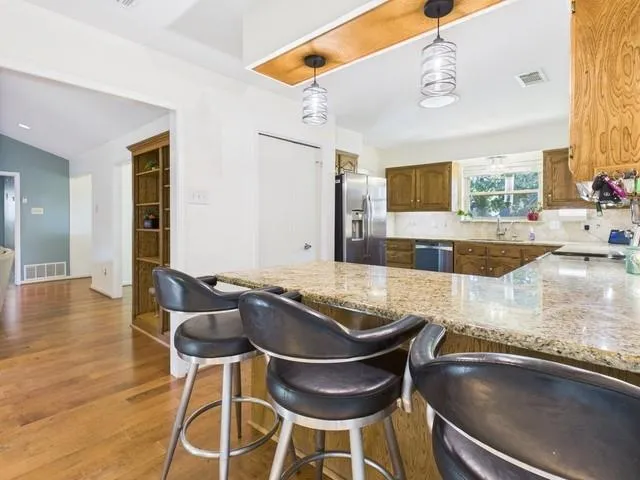 a bathroom with a granite countertop sink mirror and shower