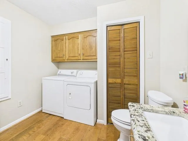 a bathroom with a granite countertop sink a mirror and a shower