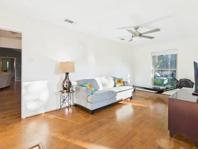 a bedroom with a bed rug and wooden floor