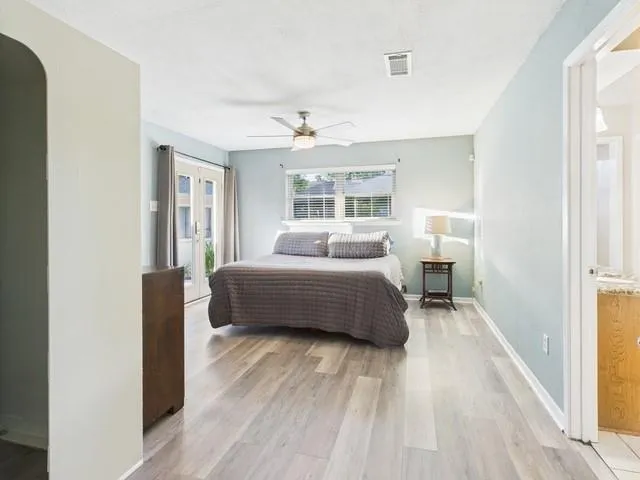 a bathroom with a granite countertop sink a toilet and a shower