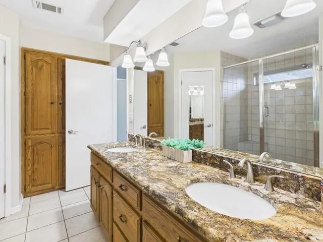 a front view of a house with a yard and table and chairs under an umbrella