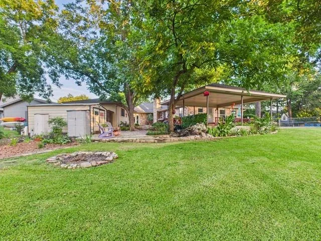 a kitchen with kitchen island granite countertop a sink cabinets and stainless steel appliances