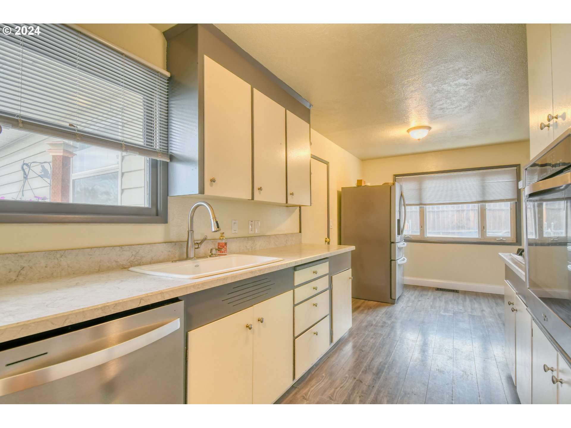 3222 Southwest Hailey Place Pendleton, OR 97801 - Photo 15 of 48 a kitchen with a sink cabinets and wooden floor