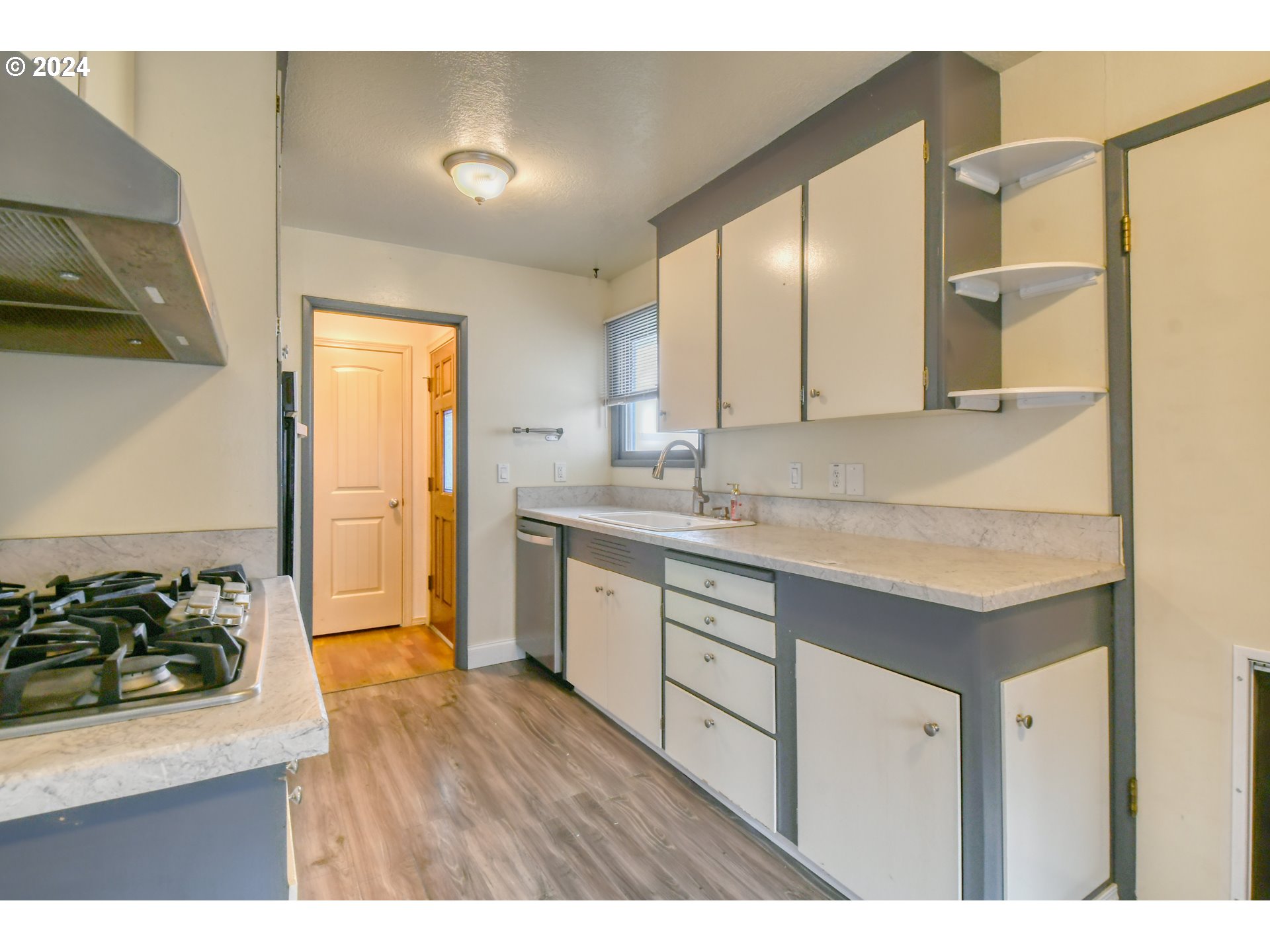 3222 Southwest Hailey Place Pendleton, OR 97801 - Photo 17 of 48 a kitchen with a sink cabinets and wooden floor