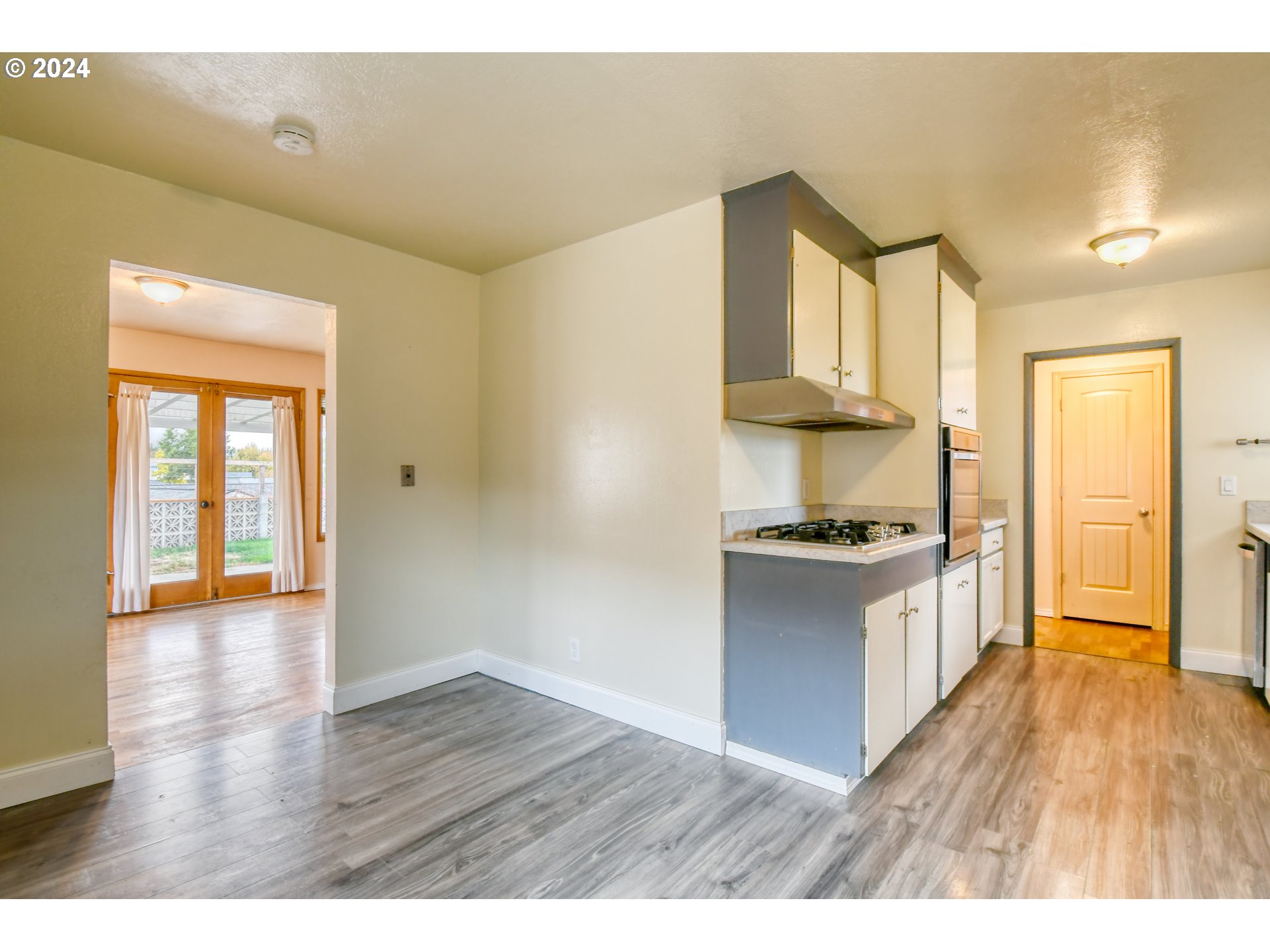3222 Southwest Hailey Place Pendleton, OR 97801 - Photo 20 of 48 a kitchen with stainless steel appliances granite countertop a stove a sink and a refrigerator with wooden floors