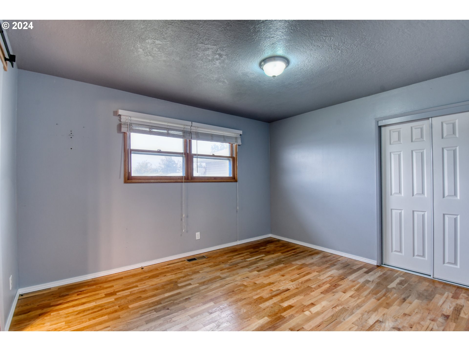 3222 Southwest Hailey Place Pendleton, OR 97801 - Photo 23 of 48 a view of empty room with wooden floor and fan
