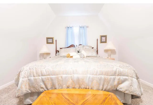 a bedroom with a bed and a mirror