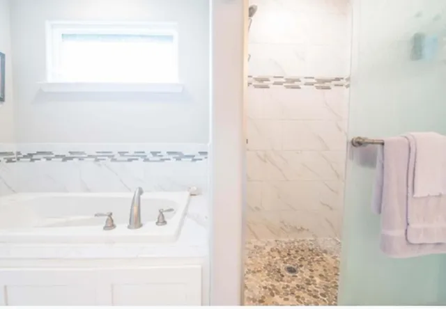 a bathroom with a bathtub and a shower