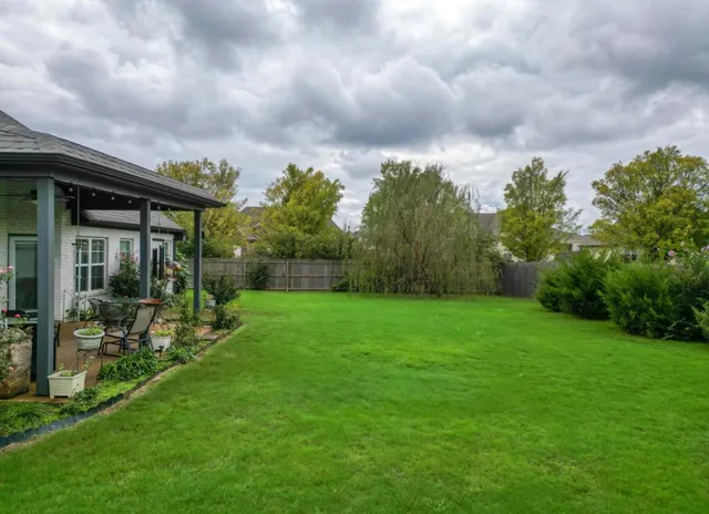a view of a house with backyard and porch