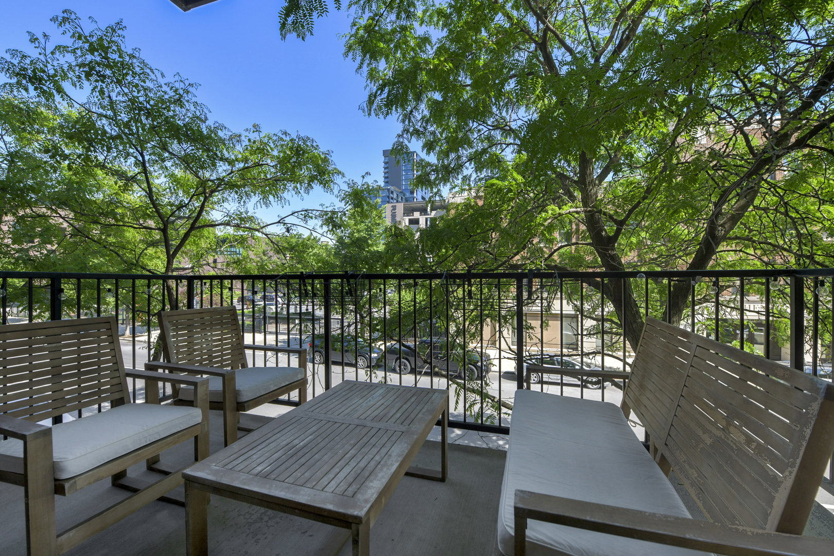 1355 West Washington Boulevard, Unit 2B Chicago, IL 60607 - Photo 14 of 16 a view of a balcony with wooden floor and outdoor seating