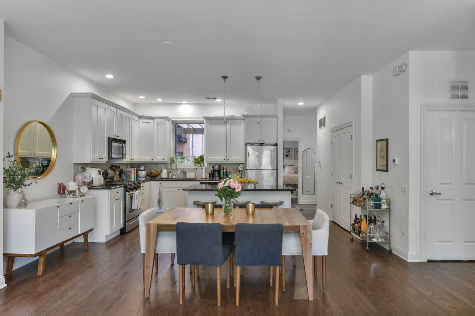 1355 West Washington Boulevard, Unit 2B Chicago, IL 60607 - Photo 4 of 16 a view of a dining room and livingroom with furniture wooden floor a chandelier