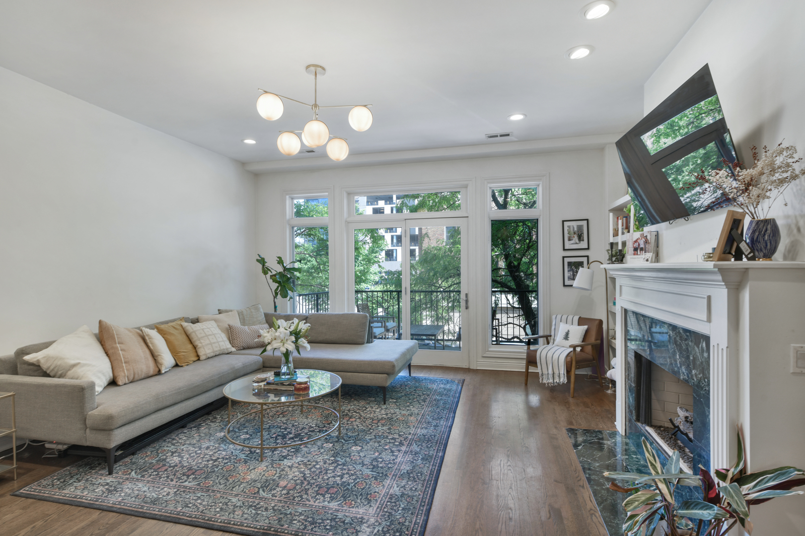 1355 West Washington Boulevard, Unit 2B Chicago, IL 60607 - Photo 7 of 16 a living room with furniture a fireplace and a flat screen tv