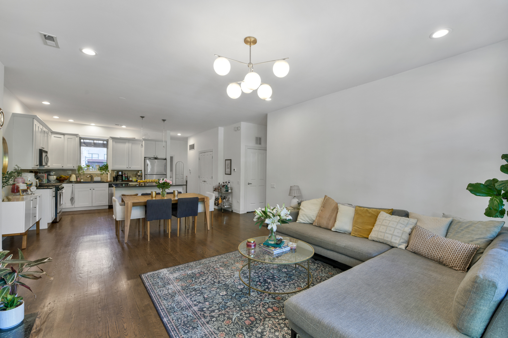1355 West Washington Boulevard, Unit 2B Chicago, IL 60607 - Photo 8 of 16 a living room with furniture and a dining table with wooden floor