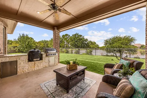 a living room with patio furniture and a garden