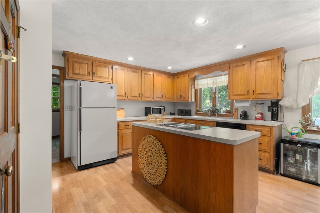 16 Parmenter Road Framingham, MA 01701 - Photo 7 of 34 a kitchen with refrigerator a stove a sink and a window