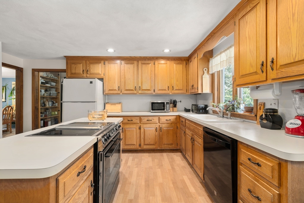 16 Parmenter Road Framingham, MA 01701 - Photo 8 of 34 a kitchen with a sink a stove a refrigerator and cabinets