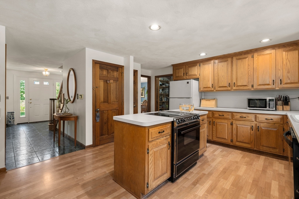 16 Parmenter Road Framingham, MA 01701 - Photo 10 of 34 a kitchen with a stove top oven sink and refrigerator