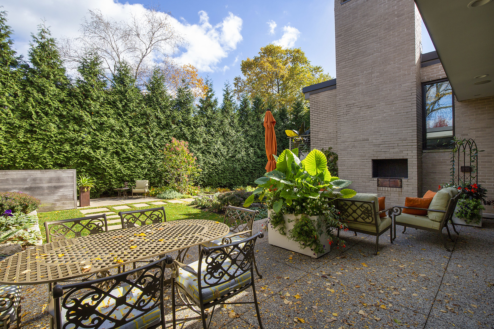 643 Sheridan Road Evanston, IL 60202 - Photo 11 of 29 a patio with table and chairs and potted plants