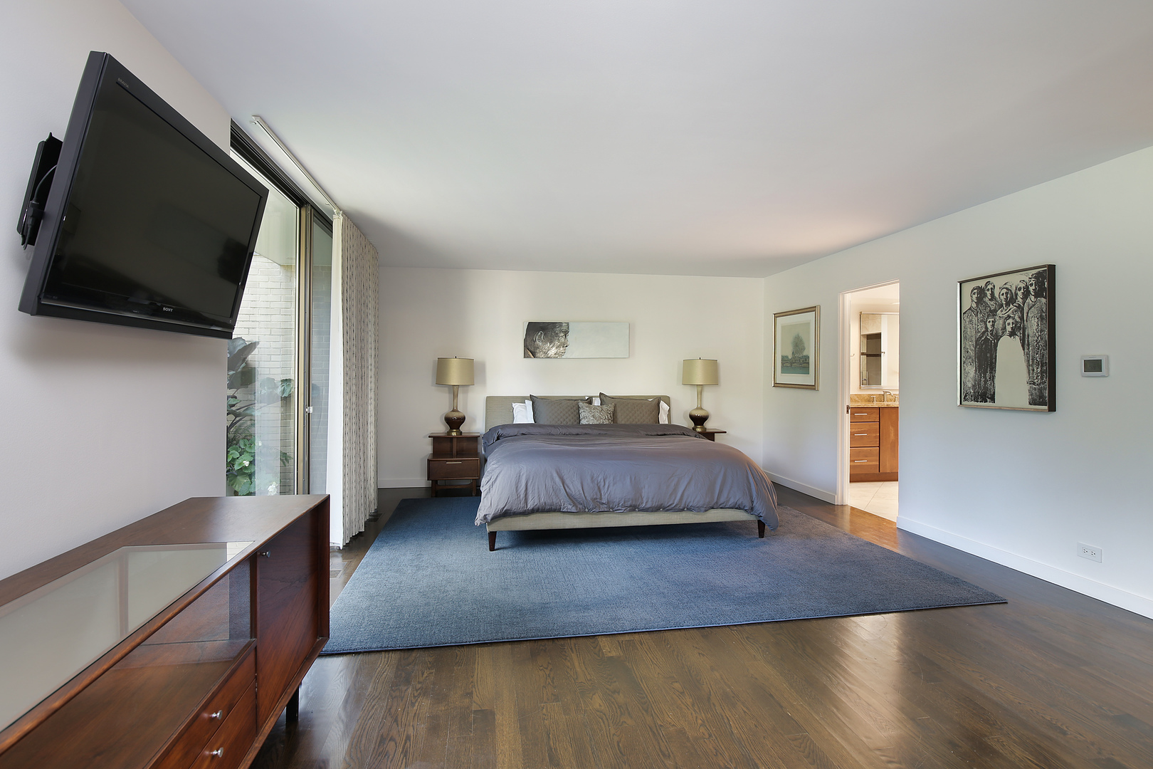 643 Sheridan Road Evanston, IL 60202 - Photo 15 of 29 a spacious bedroom with a bed and a flat screen tv