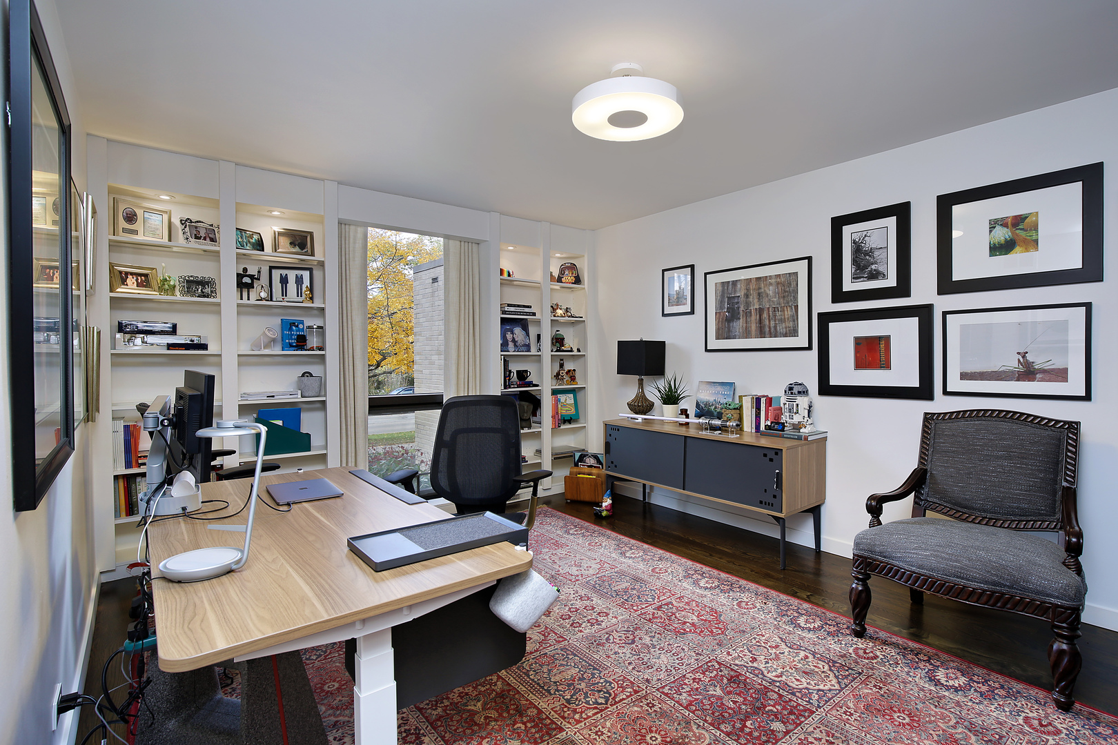 643 Sheridan Road Evanston, IL 60202 - Photo 21 of 29 a living room with furniture a rug and a bookshelf