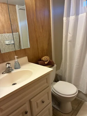 a bathroom with a toilet and shower