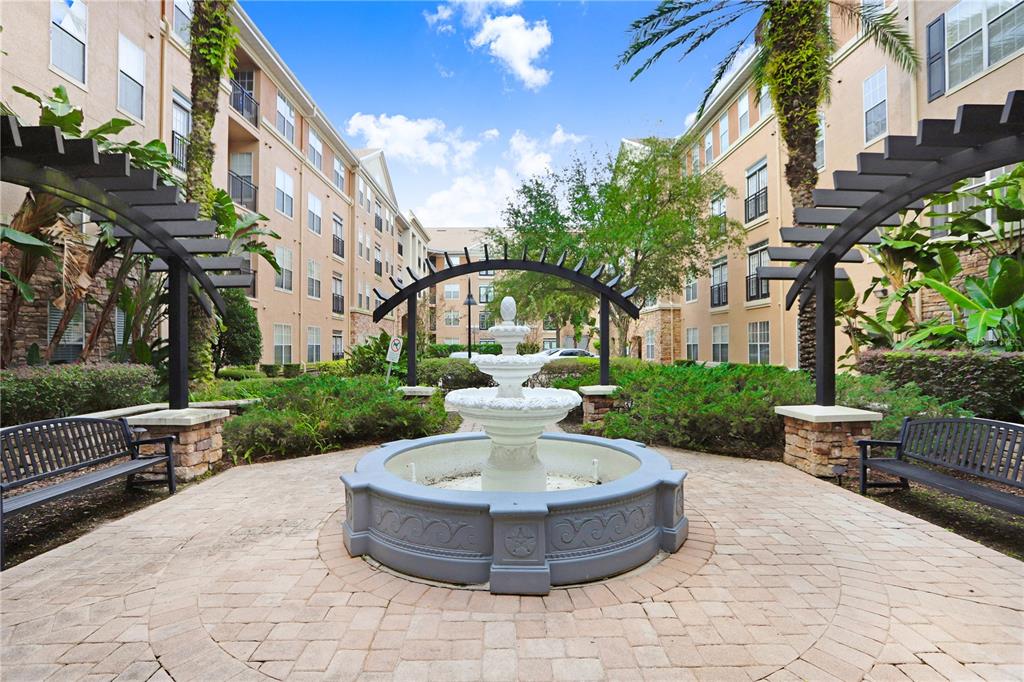 a view of a fountain in the yard of the house