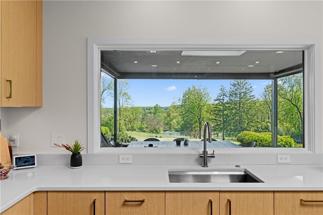 1506 Pleasant View Road Coopersburg, PA 18036 - Photo 34 of 97 A spacious kitchen features a large window, offering serene views of the surrounding natural landscape.