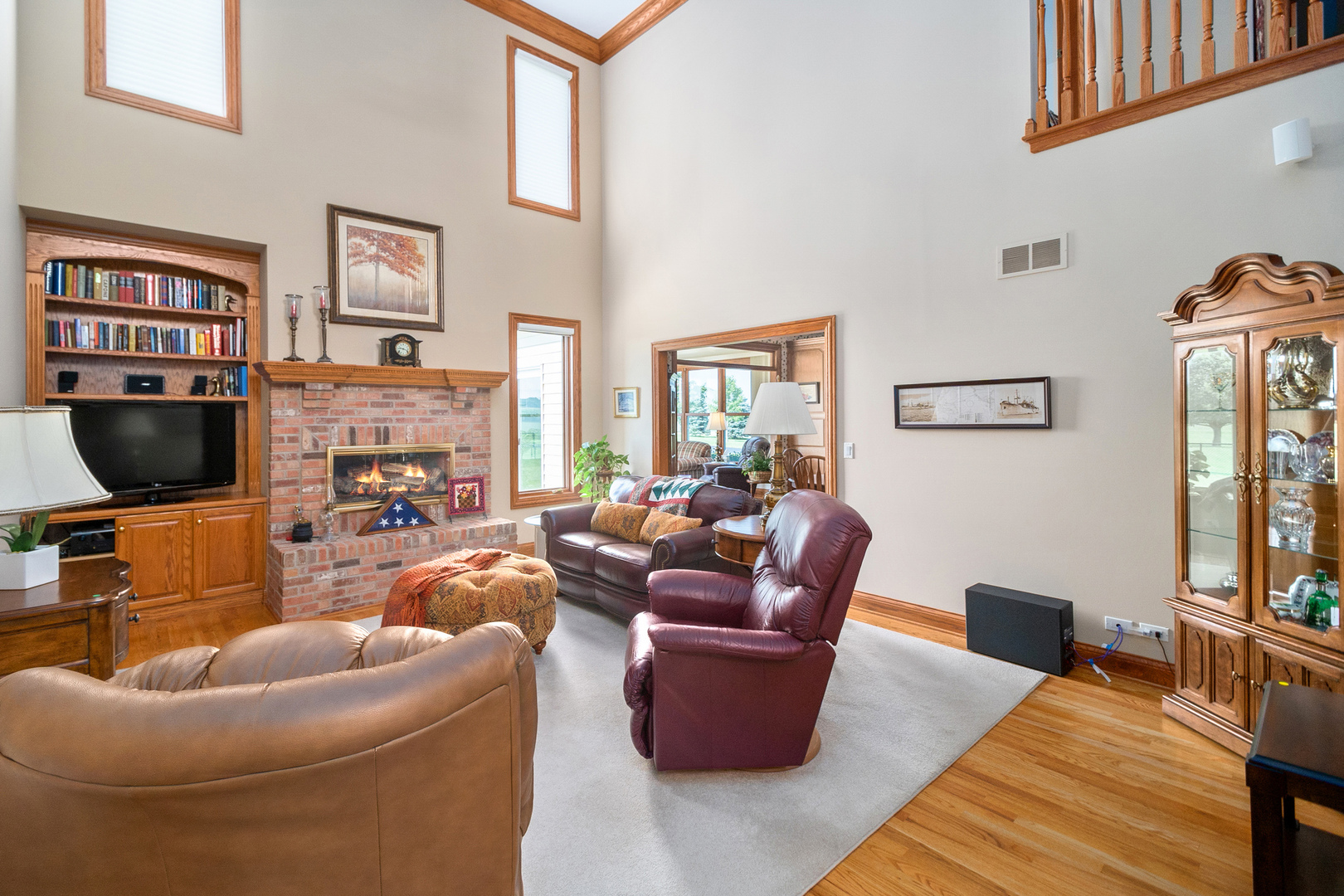 42W545 McDonald Road Elgin, IL 60124 - Photo 11 of 45 a living room with furniture a flat screen tv and a fireplace