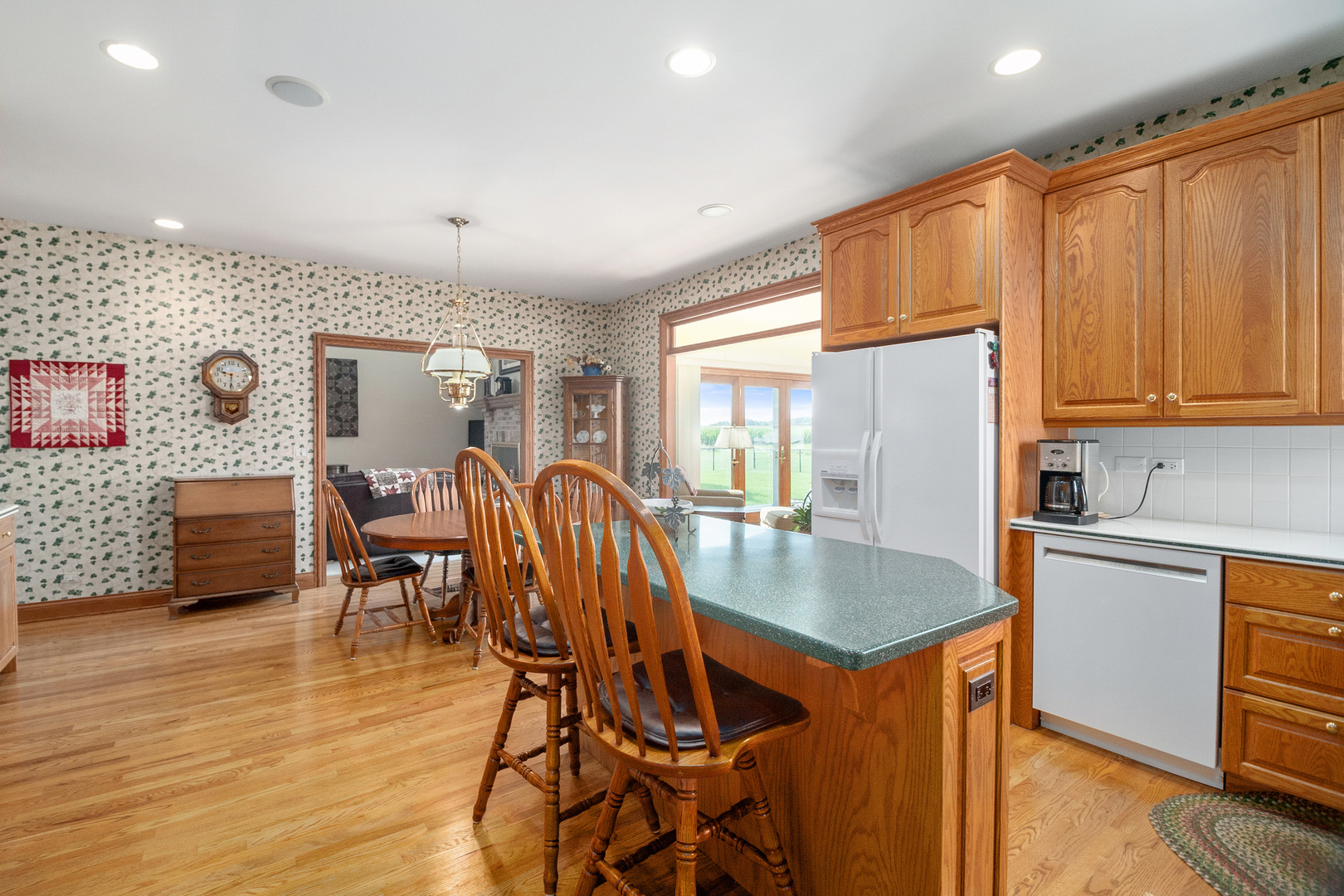 42W545 McDonald Road Elgin, IL 60124 - Photo 14 of 45 a kitchen with stainless steel appliances granite countertop a table chairs and a refrigerator