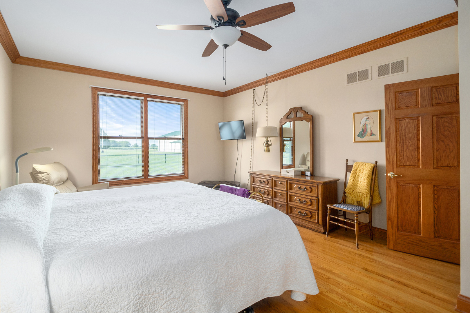 42W545 McDonald Road Elgin, IL 60124 - Photo 23 of 45 a bedroom with a large bed a chandelier and dresser