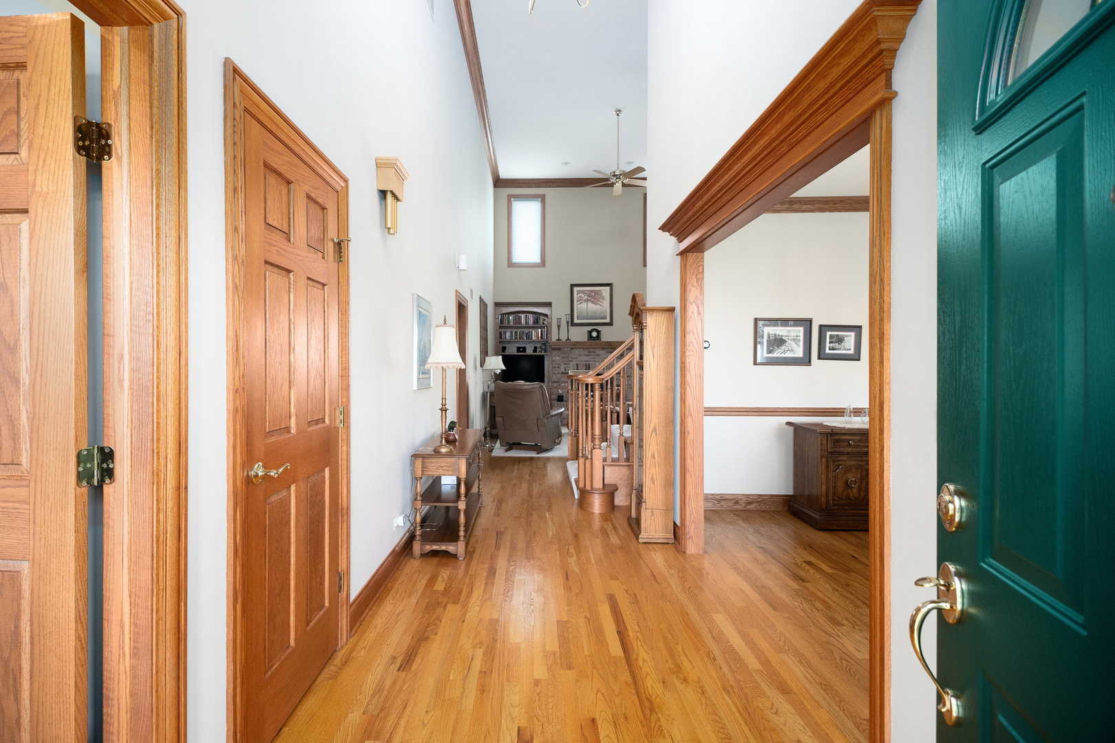42W545 McDonald Road Elgin, IL 60124 - Photo 4 of 45 a view of a hallway with wooden floor windows and a livingroom with furniture