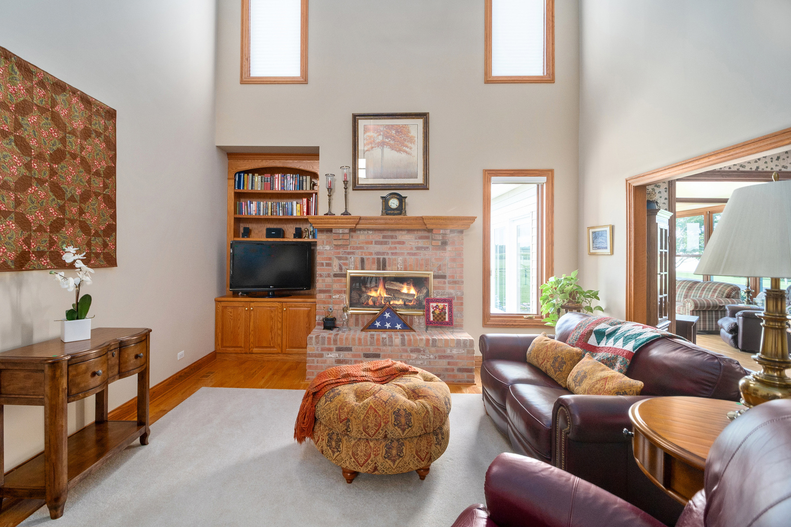 42W545 McDonald Road Elgin, IL 60124 - Photo 10 of 45 a living room with furniture a fireplace and a flat screen tv