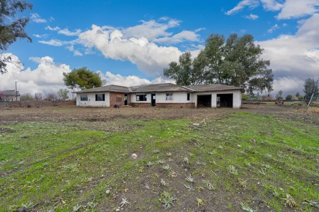 a backyard of a house with garage