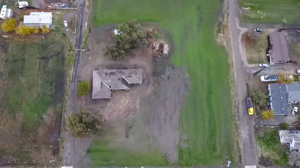 an aerial view of a house with a yard