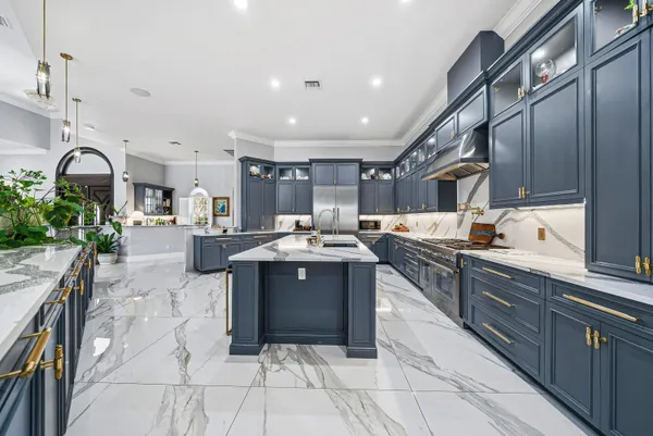 a living room with furniture a chandelier and a flat screen tv