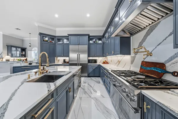 a living room with stainless steel appliances kitchen island granite countertop furniture and a kitchen view