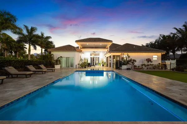 a swimming pool view with a outdoor seating
