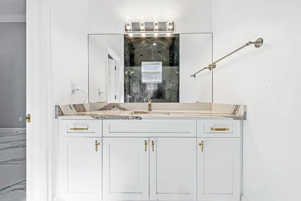 a bathroom with a double vanity sink a mirror and a shower