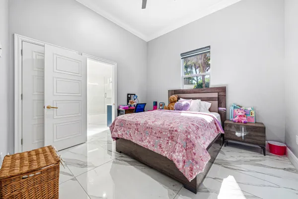 a hallway with white cabinets and wooden floor