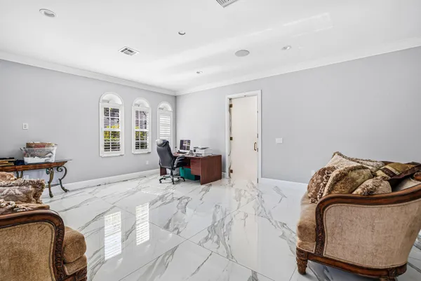 a view of swimming pool with outdoor seating and palm tree