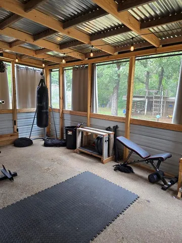 a room with gym equipment and a large window