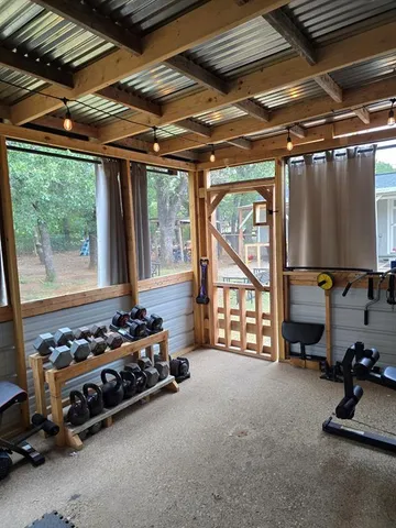a room with gym equipment and a large window