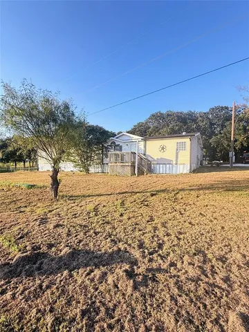 a backyard of a house with swing and slide