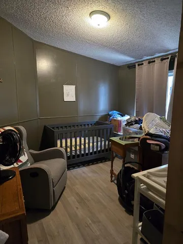 a bathroom with a granite countertop sink a large mirror and a bathtub