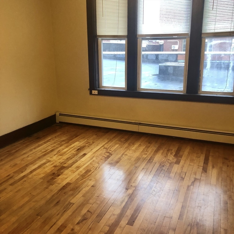 27 High Street, Unit 1 Clinton, MA 01510 - Photo 19 of 30 a view of an empty room and wooden floor and a window