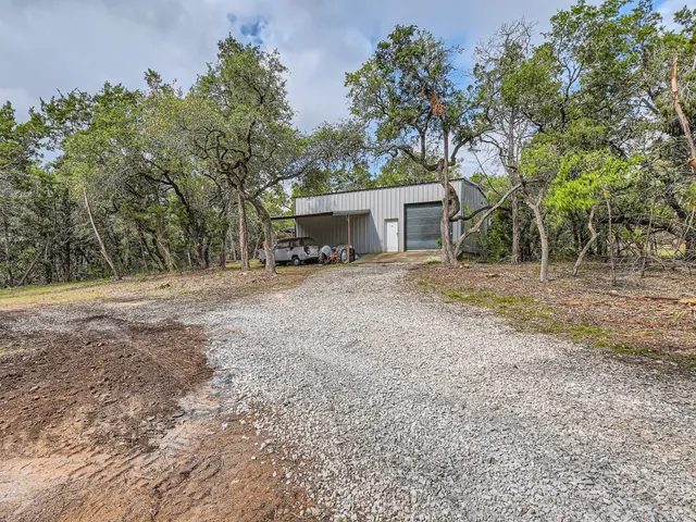 a view of a house with large trees